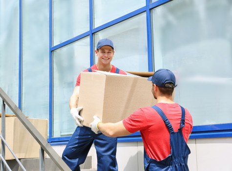 Furniture and boxes being loaded into a removal van