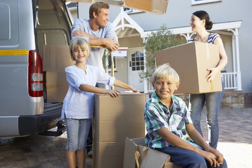 Removal team packing boxes and furniture for a home move